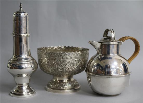 An Indian white metal embossed footed bowl, a plated Guernsey cream jug and a plated sugar caster